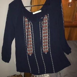 Long sleeve, dark blue shirt.